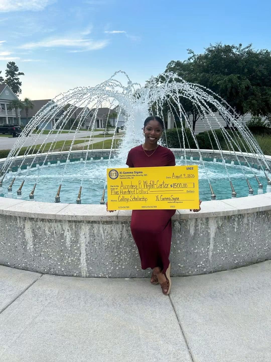 Avondrea Wigfall-Carter holding her $500 Xi Gamma Sigma college scholarship award